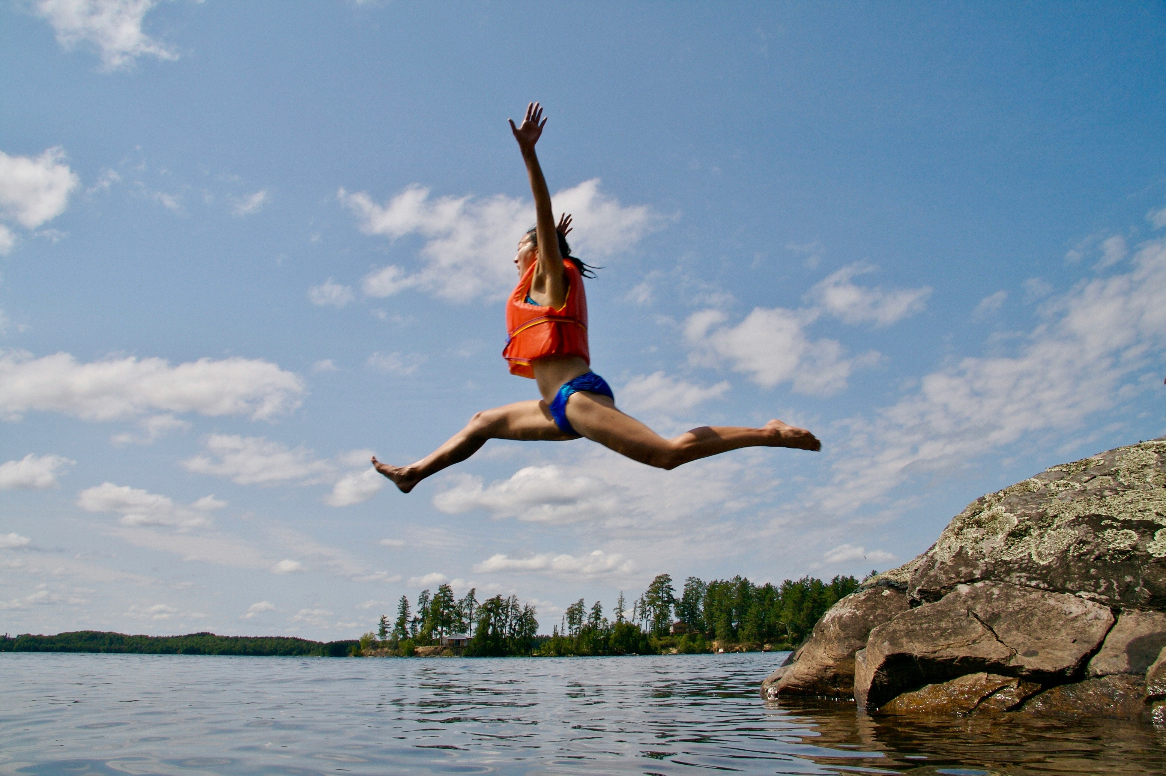 woman jumping into water - blog by makers of organic cold-pressed fruit and vegetable Living Juice